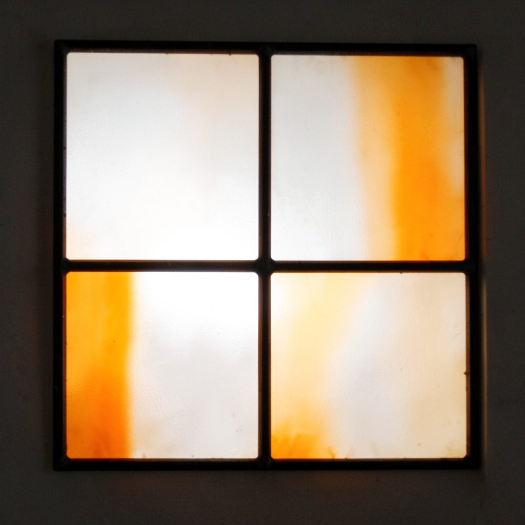 Stained-glass square in soft white and warm amber, minimal divisions