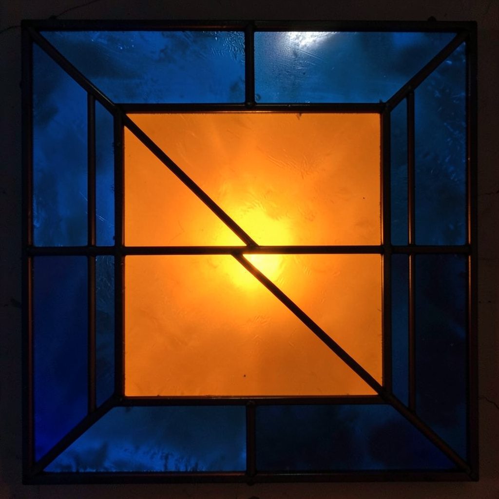 Stained-glass square in deep blue and charcoal, broad leaded panels